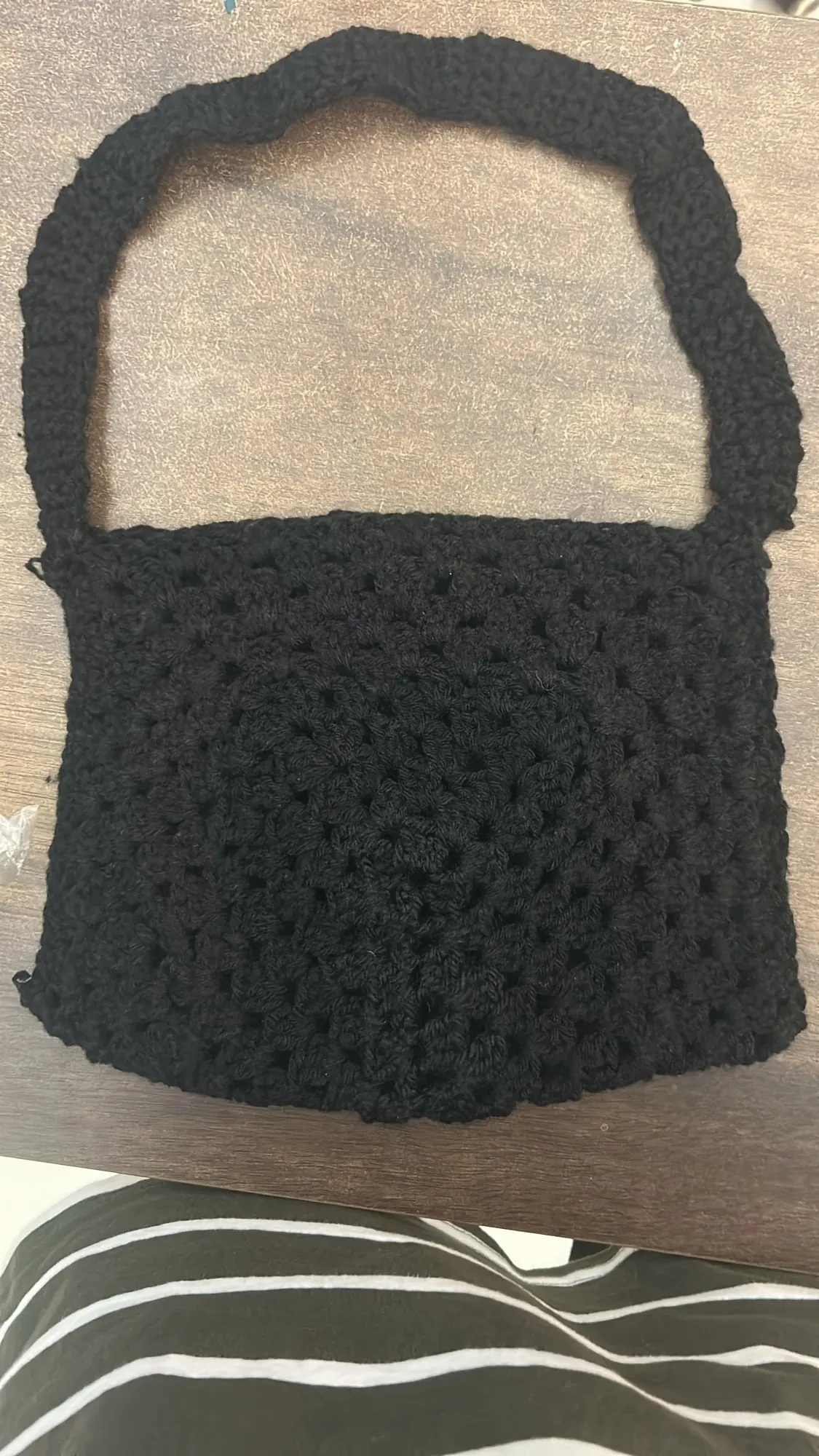A black crochet patchwork tote bag