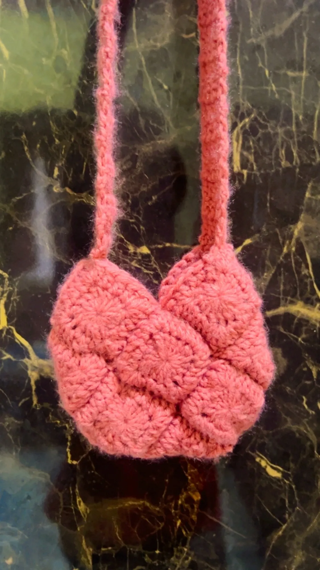 A rose pink crochet crossbody pouch