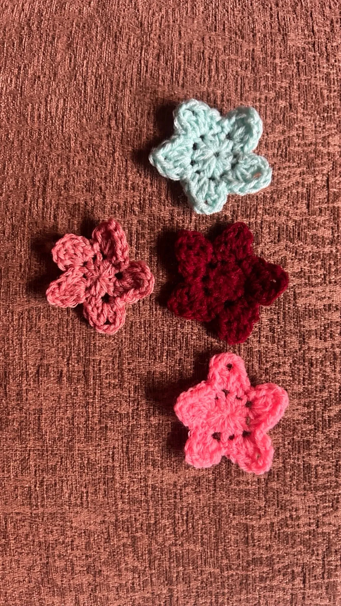 Four small crochet flowers